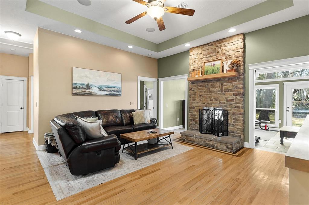 10616 Poe Street Leesburg, FL 34788 - Photo 11 of 54 a living room with furniture and a fireplace