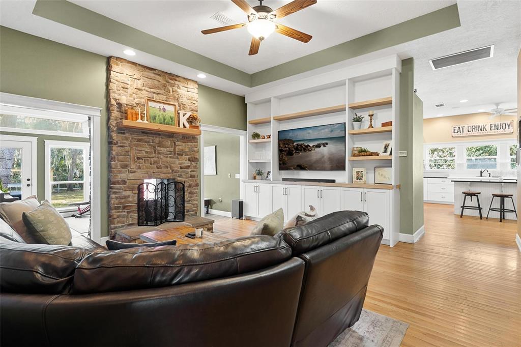 10616 Poe Street Leesburg, FL 34788 - Photo 12 of 54 a living room with furniture and a flat screen tv