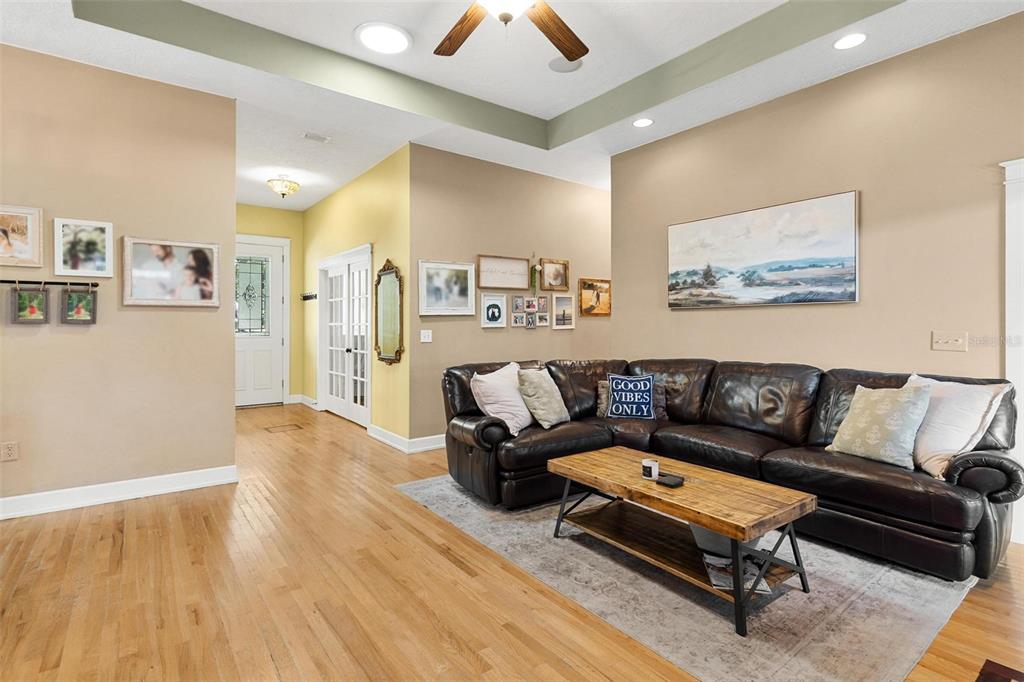 10616 Poe Street Leesburg, FL 34788 - Photo 13 of 54 a living room with furniture and a wooden floor