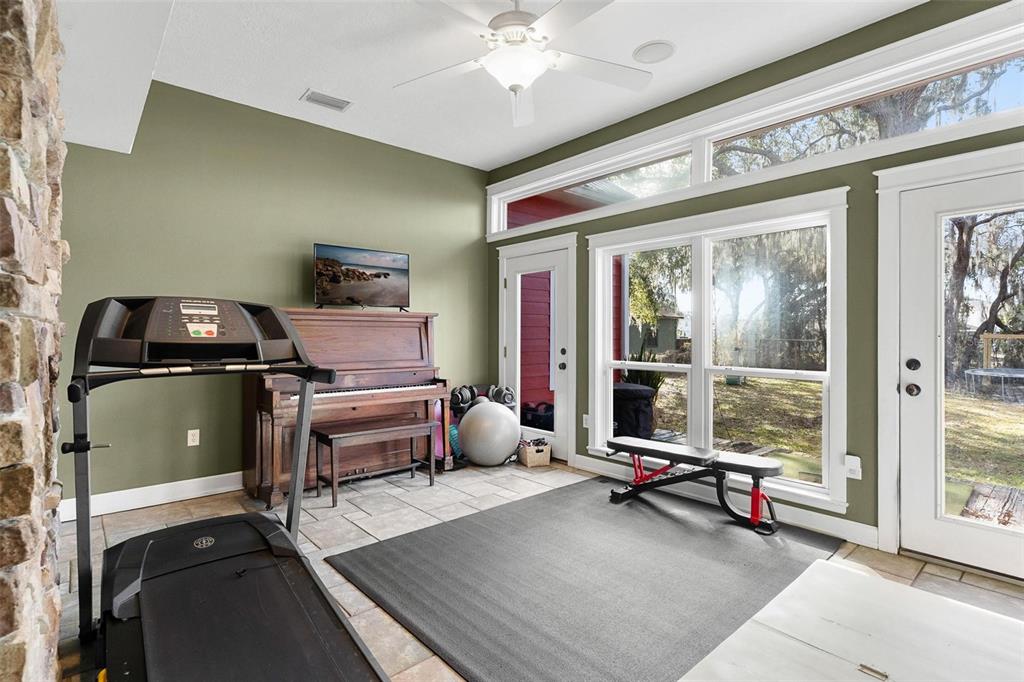 10616 Poe Street Leesburg, FL 34788 - Photo 15 of 54 a bedroom with furniture and a large window