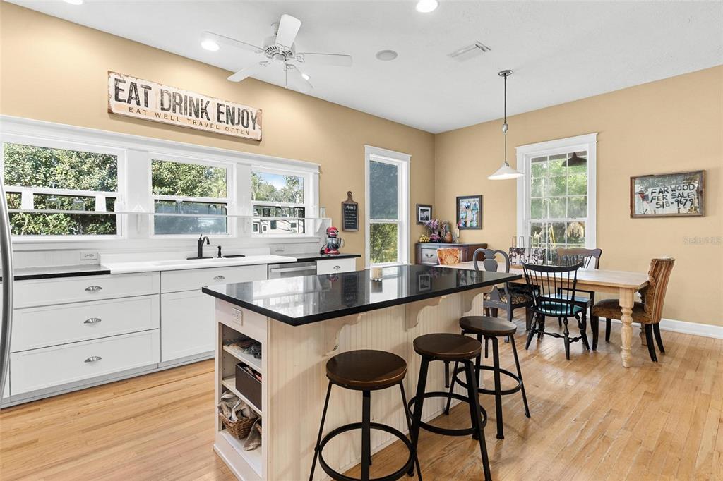 10616 Poe Street Leesburg, FL 34788 - Photo 17 of 54 a large kitchen with a table and chairs