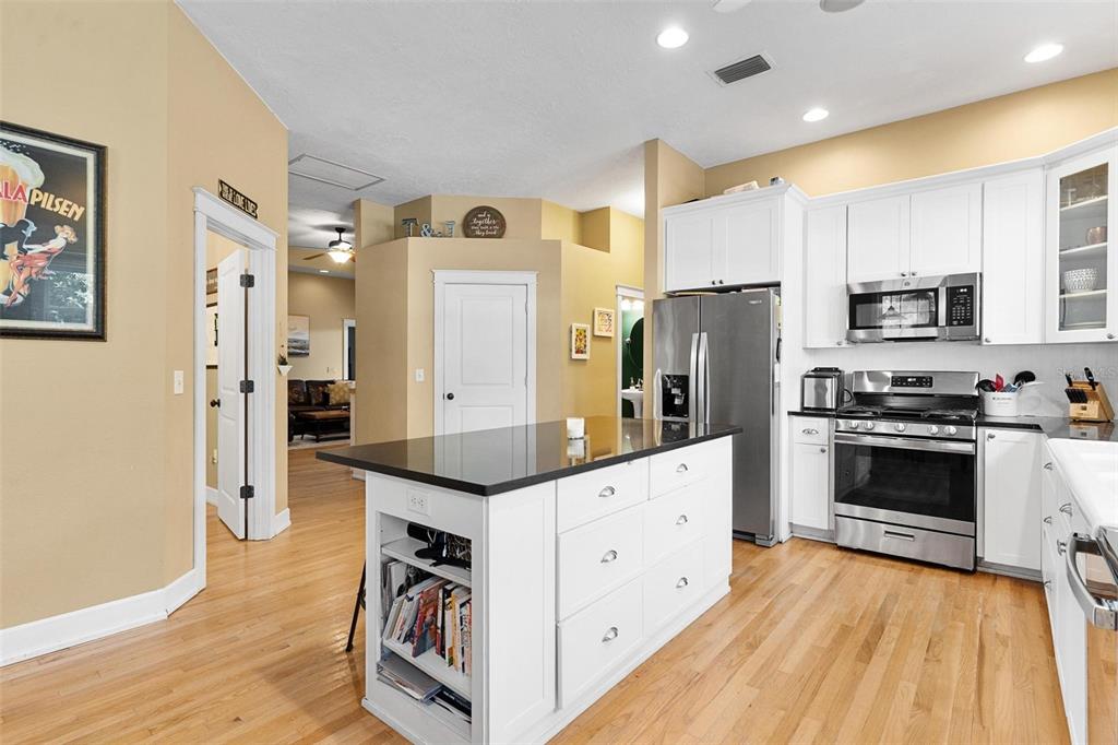10616 Poe Street Leesburg, FL 34788 - Photo 21 of 54 a kitchen with stainless steel appliances a refrigerator sink and microwave
