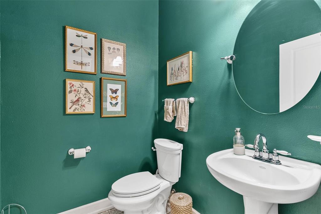 10616 Poe Street Leesburg, FL 34788 - Photo 25 of 54 a bathroom with a toilet sink and mirror