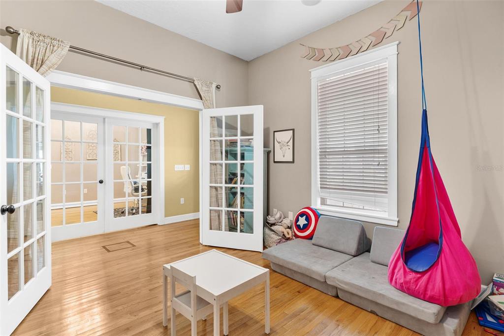 10616 Poe Street Leesburg, FL 34788 - Photo 29 of 54 a living room with a couch and wooden floor
