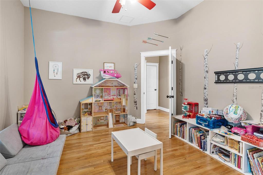 10616 Poe Street Leesburg, FL 34788 - Photo 30 of 54 a living room with furniture and a wooden floor