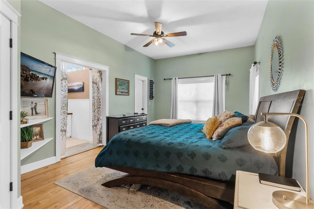 10616 Poe Street Leesburg, FL 34788 - Photo 32 of 54 a bedroom with a bed and dresser with mirror