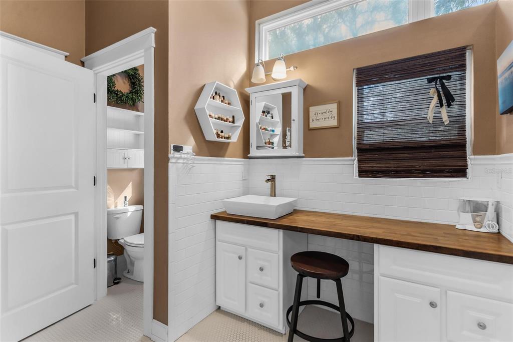 10616 Poe Street Leesburg, FL 34788 - Photo 33 of 54 a bathroom with a sink and a mirror