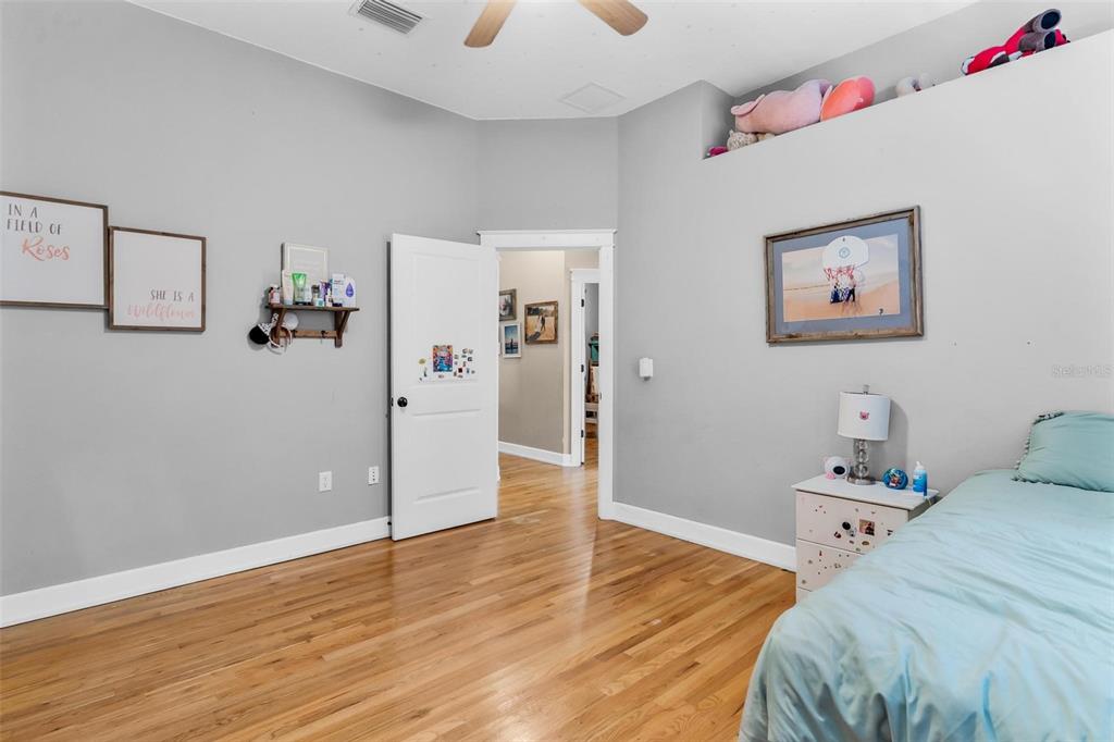 10616 Poe Street Leesburg, FL 34788 - Photo 42 of 54 a bedroom with a bed and wooden floor