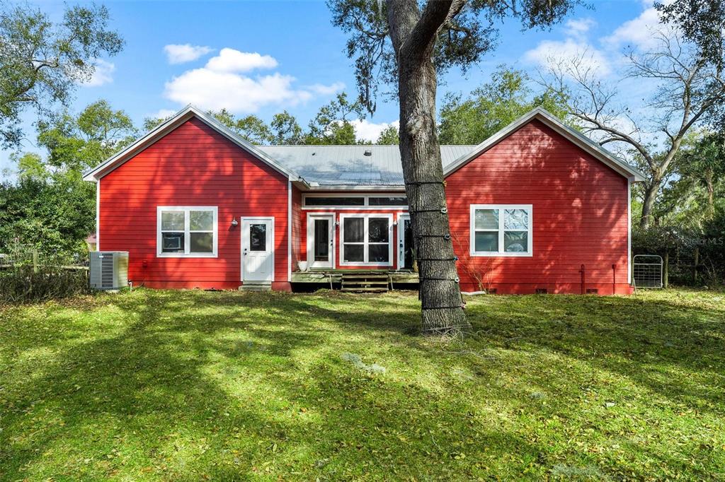 10616 Poe Street Leesburg, FL 34788 - Photo 45 of 54 a view of a house with a yard