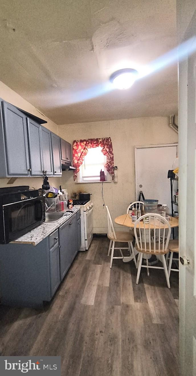 5330 Lesher Street Philadelphia, PA 19124 - Photo 5 of 14 a kitchen with sink cabinets and window