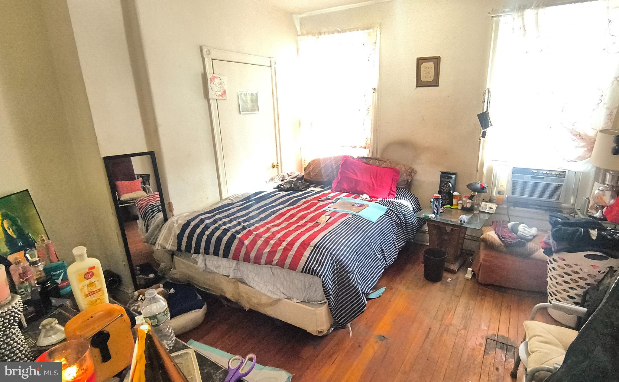 5330 Lesher Street Philadelphia, PA 19124 - Photo 9 of 14 a bedroom with a bed and wooden floor