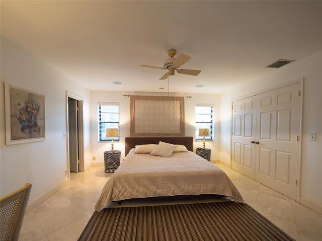 a bedroom with a large bed a lamp and a window