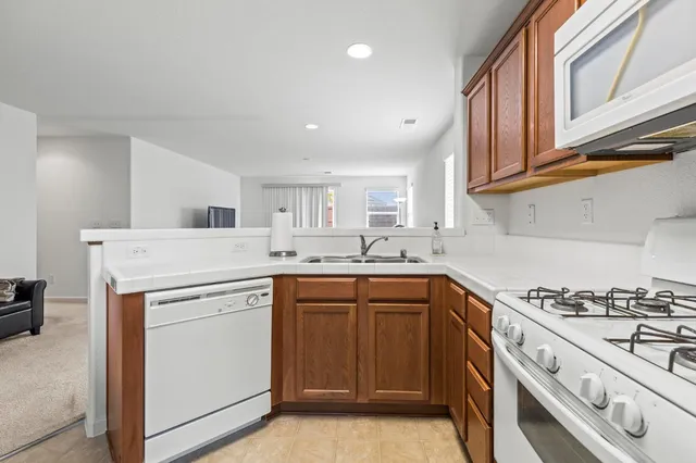a kitchen with granite countertop cabinets stainless steel appliances and sink