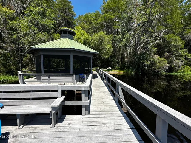 a view of house with roof deck and seating space