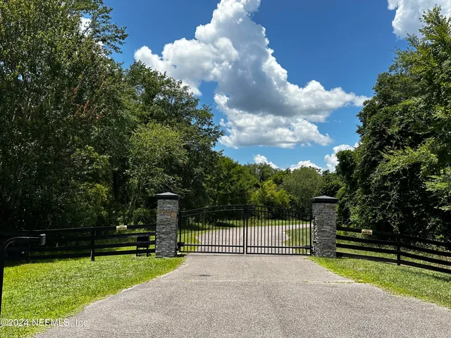 a view of a garden with wooden fence