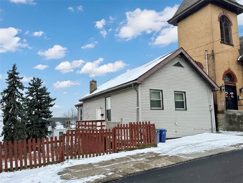 a view of a house with wooden fence