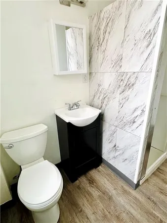 a bathroom with a sink toilet and mirror