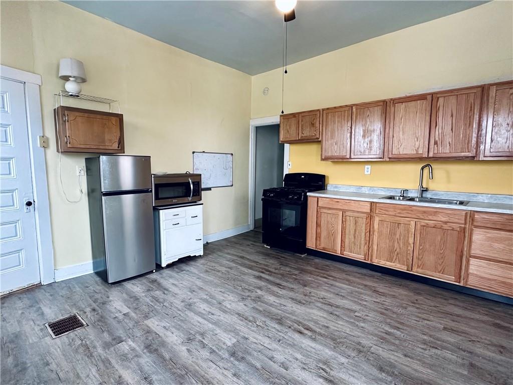 435 Catoma Street Pittsburgh, PA 15212 - Photo 8 of 9 a kitchen with stainless steel appliances granite countertop a refrigerator a stove top oven a sink and dishwasher