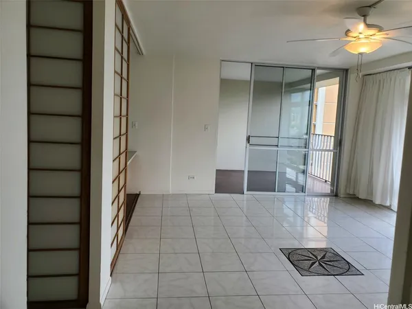 wooden floor in an empty room with a bathroom