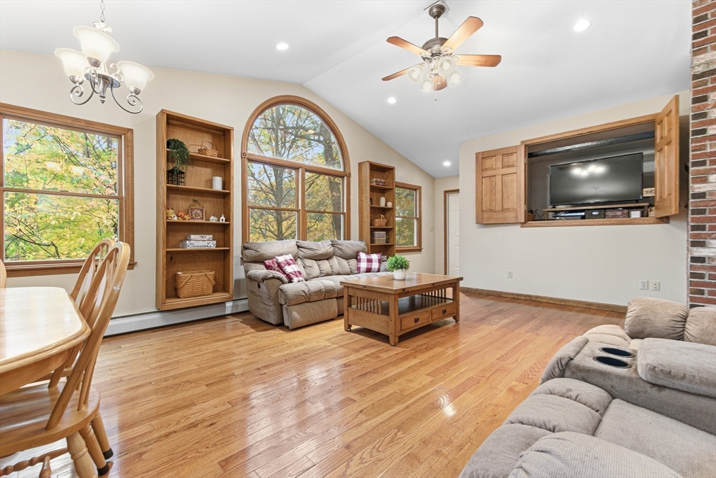 7 John Street Southborough, MA 01772 - Photo 11 of 30 a living room with furniture a flat screen tv and a large window