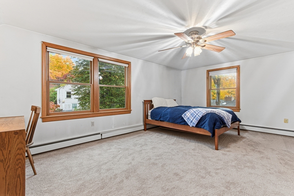 7 John Street Southborough, MA 01772 - Photo 21 of 30 a spacious bedroom with a bed and a large window