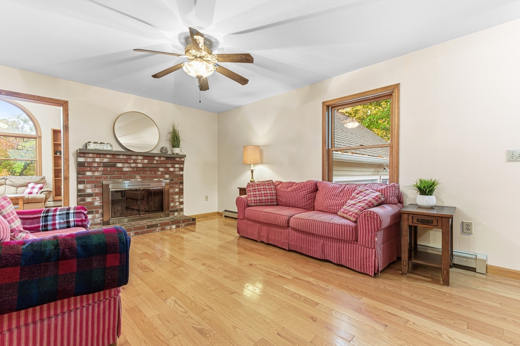 7 John Street Southborough, MA 01772 - Photo 4 of 30 a living room with furniture a fireplace and a large window