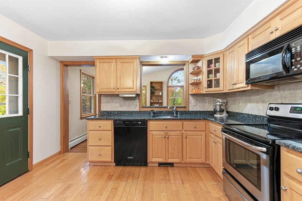 7 John Street Southborough, MA 01772 - Photo 6 of 30 a kitchen with stainless steel appliances granite countertop a stove and a sink