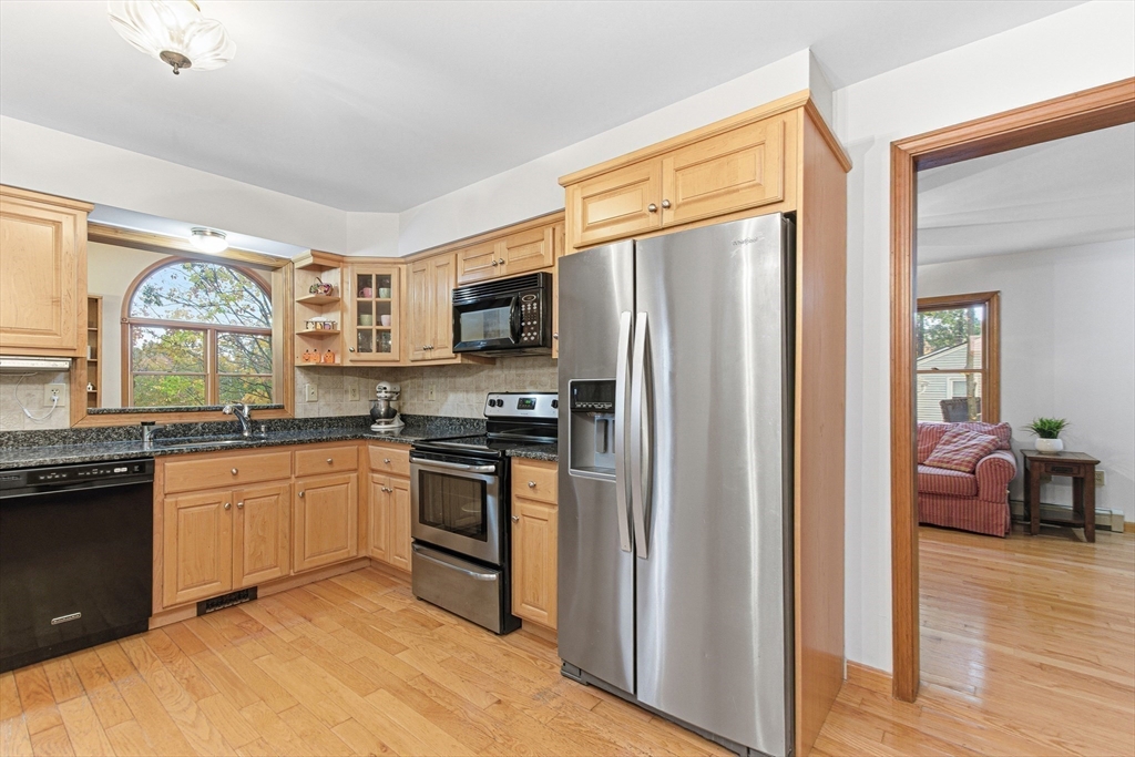7 John Street Southborough, MA 01772 - Photo 7 of 30 a kitchen with stainless steel appliances granite countertop a refrigerator stove top oven and sink