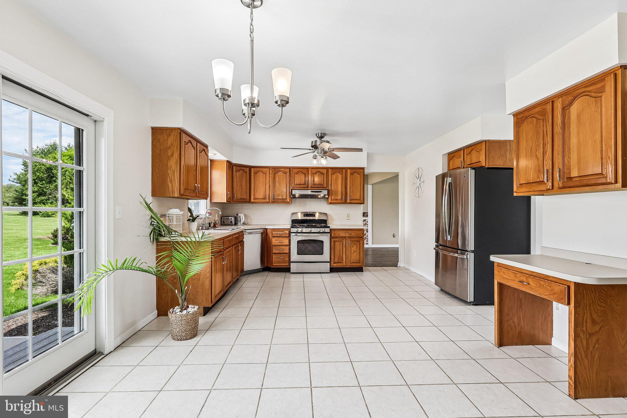 2 Carney Way Hamilton, NJ 08620 - Photo 18 of 72 a kitchen with stainless steel appliances granite countertop a stove a sink dishwasher a refrigerator cabinets and couches with wooden floor