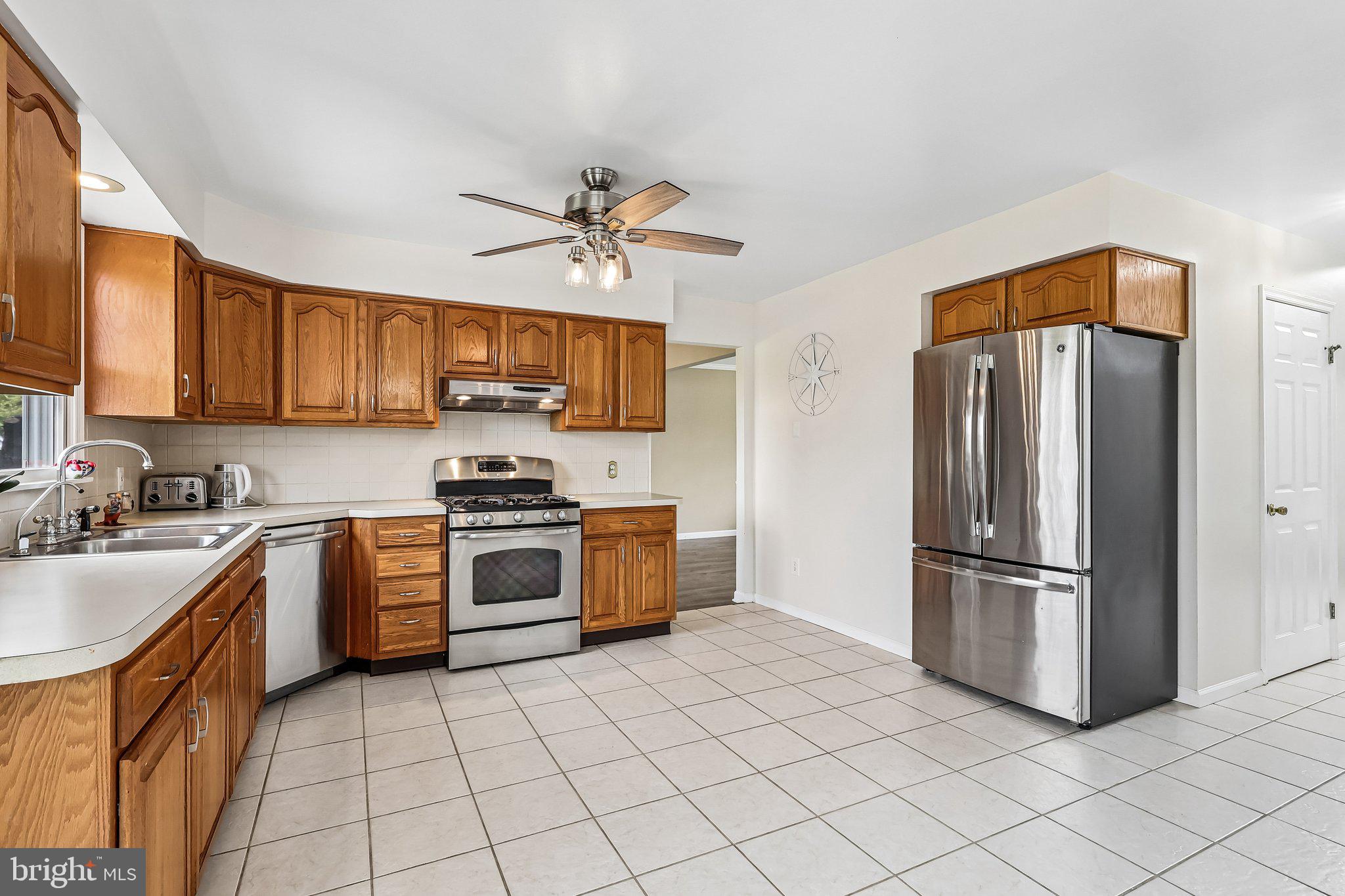 2 Carney Way Hamilton, NJ 08620 - Photo 20 of 72 a kitchen with stainless steel appliances granite countertop a stove top oven a refrigerator and a sink
