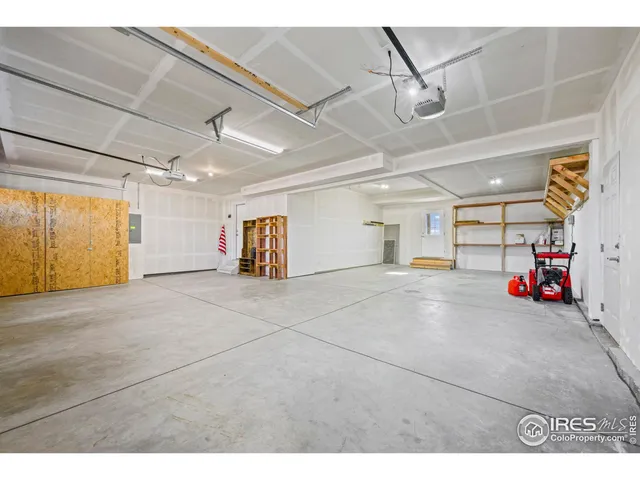 a view of a garage with rack and bicycle