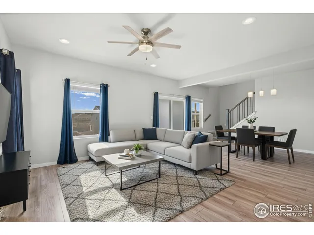 a living room with furniture and view of kitchen