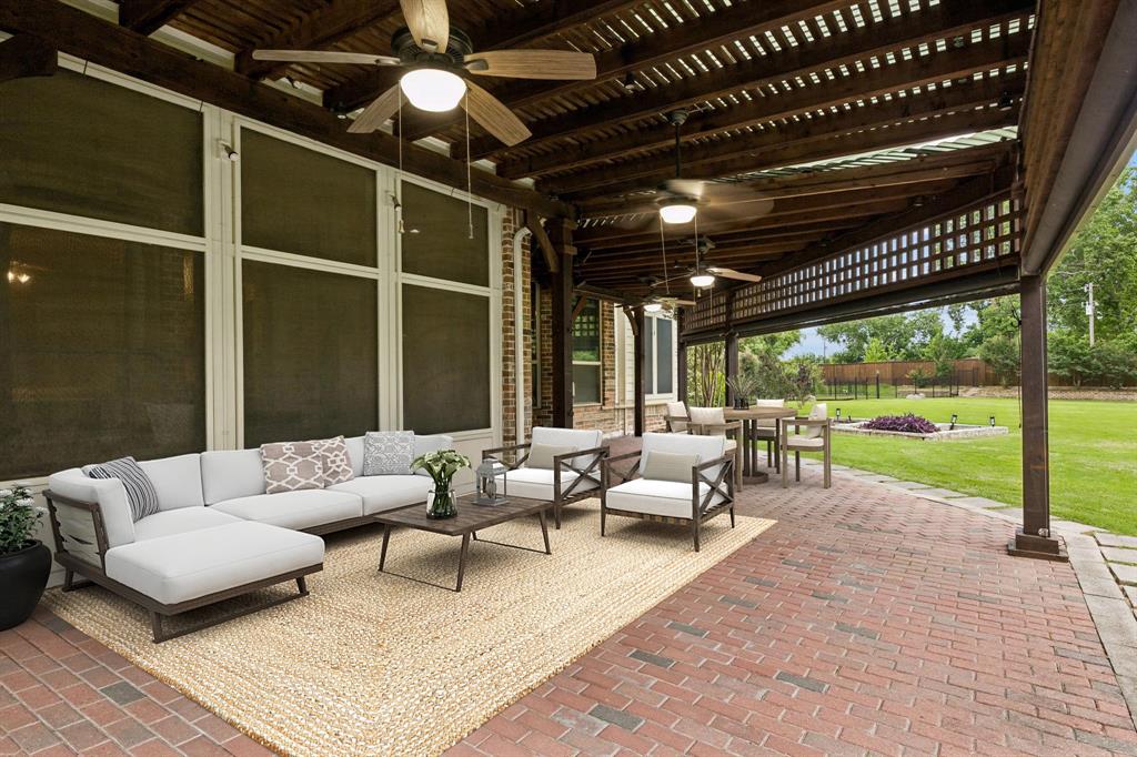 5802 Corinth Chapel Road Parker, TX 75002 - Photo 33 of 40 The backyard boasts a beautiful paver patio shaded by wood arbors, perfect for relaxing or entertaining.