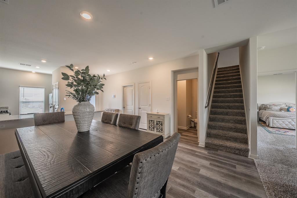8125 White Sulphur Road Ponder, TX 76259 - Photo 8 of 38 Open-concept living area featuring recessed lighting, wood-finish flooring, and a carpeted staircase