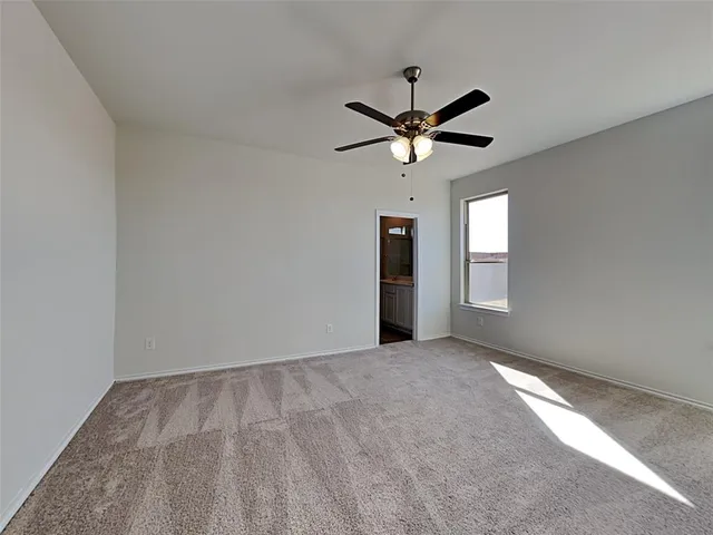 an empty room with closet and windows