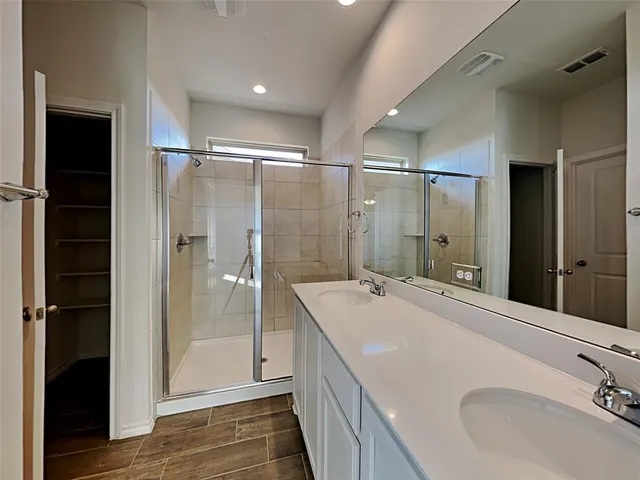 a bathroom with a sink and shower
