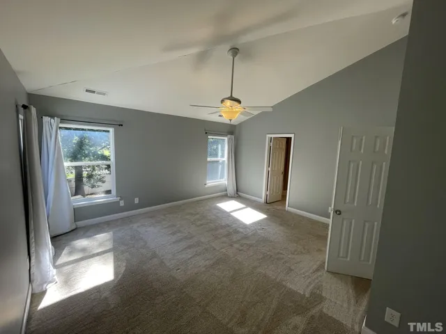 a view of empty room with window and fireplace