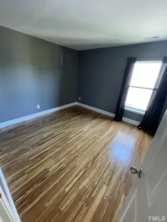 a view of an empty room and wooden floor
