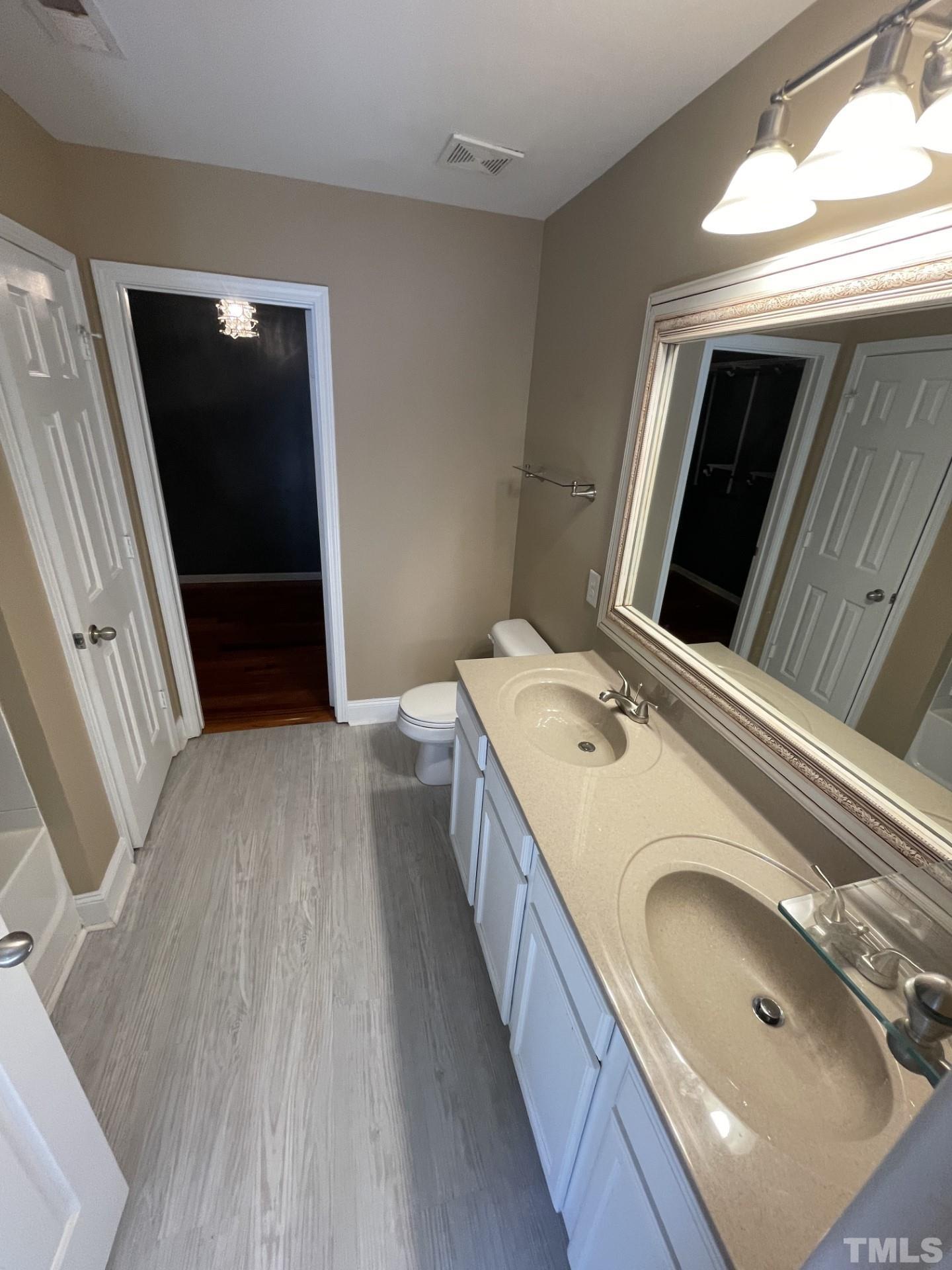 152 Solheim Lane Raleigh, NC 27603 - Photo 16 of 25 a bathroom with a sink a toilet and mirror