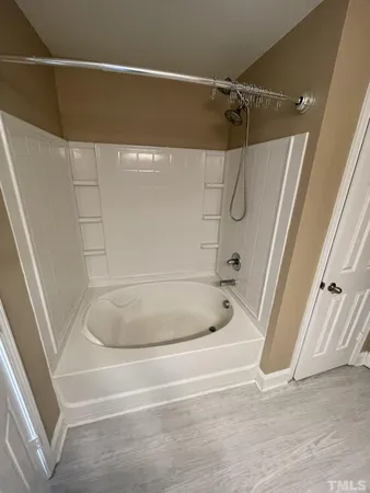 a bathroom with a bath tub and a shower