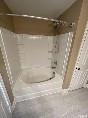 a bathroom with a bath tub and a shower