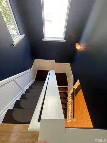 a view of staircase with wooden floor and window