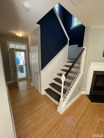 a view of entryway and hall with wooden floor