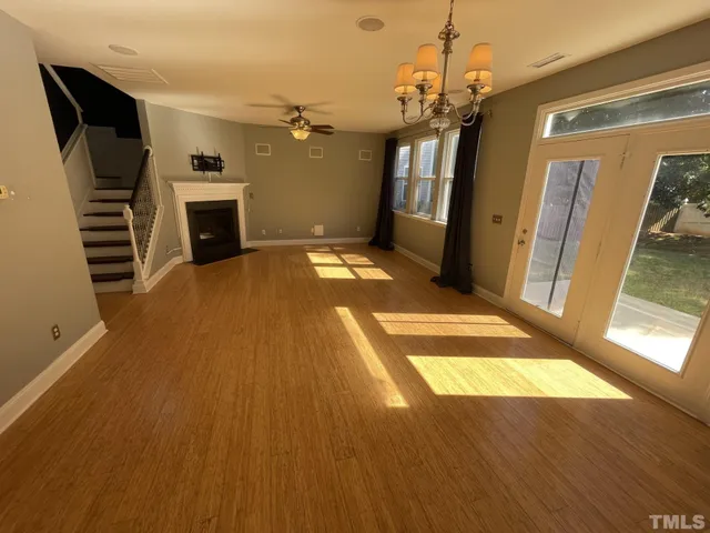 a view of a livingroom with wooden floor and a ceiling fan