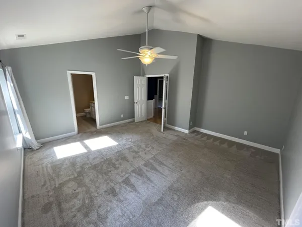 a view of a livingroom with a chandelier fan
