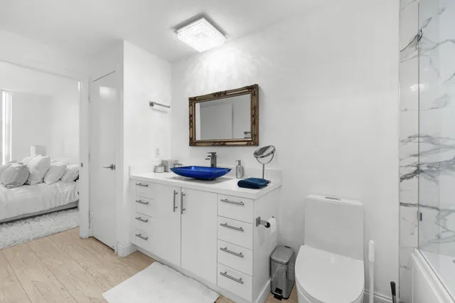 a bathroom with a toilet sink and mirror
