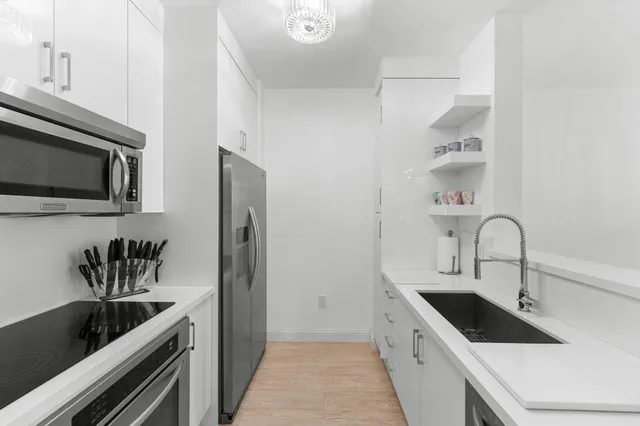 a kitchen with a sink and refrigerator