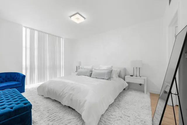 a bedroom with a bed and a window