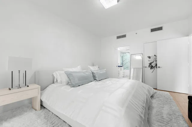 a bedroom with a bed and a table