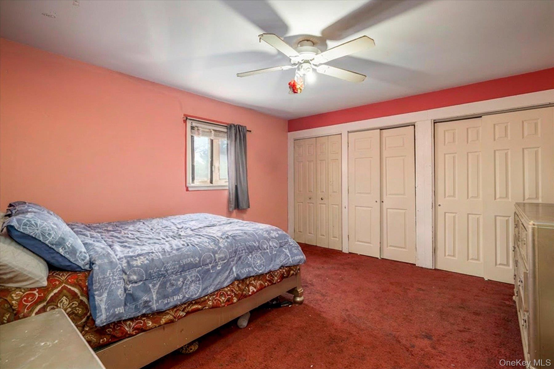 3447 Steven Road Baldwin, NY 11510 - Photo 12 of 23 a bedroom with a large bed and a chandelier
